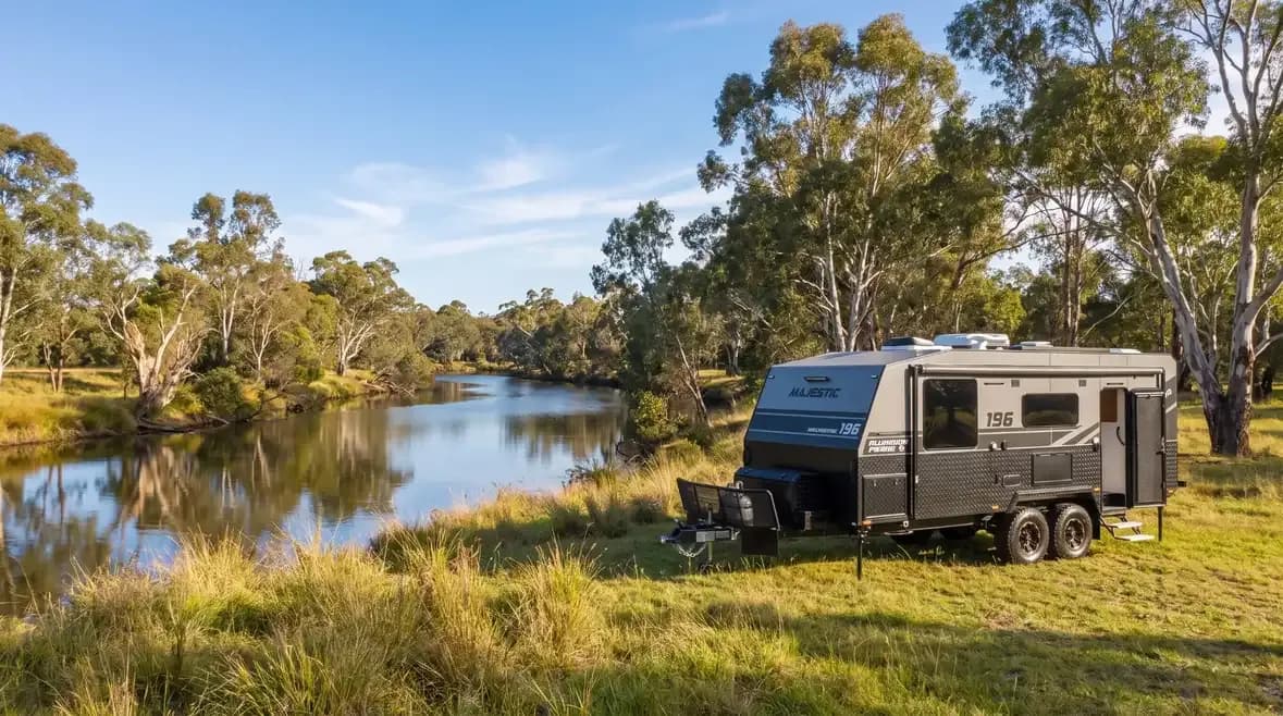 Navigator 196 camped on a riverbank among gum trees